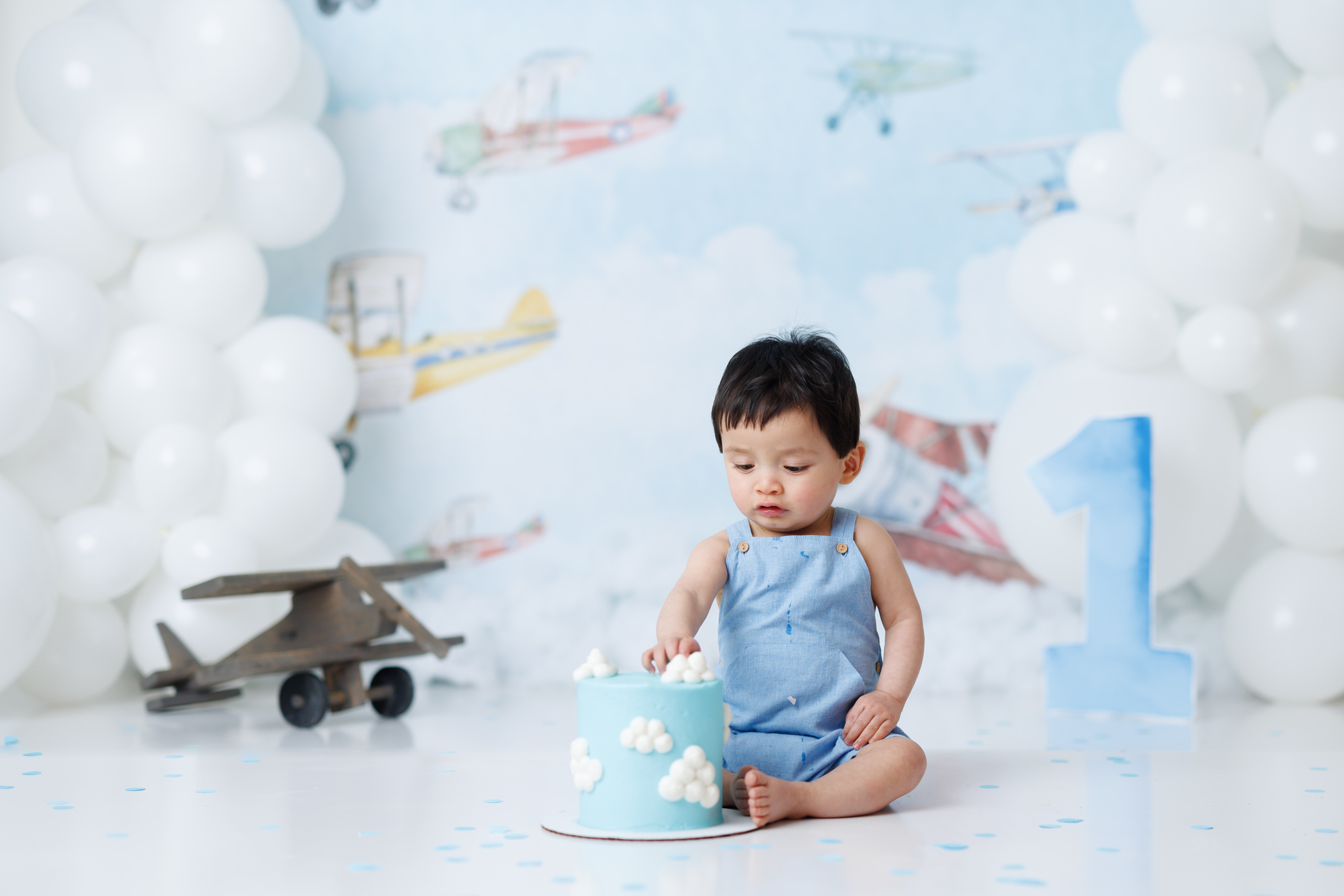 boy eating cake with clouds on it