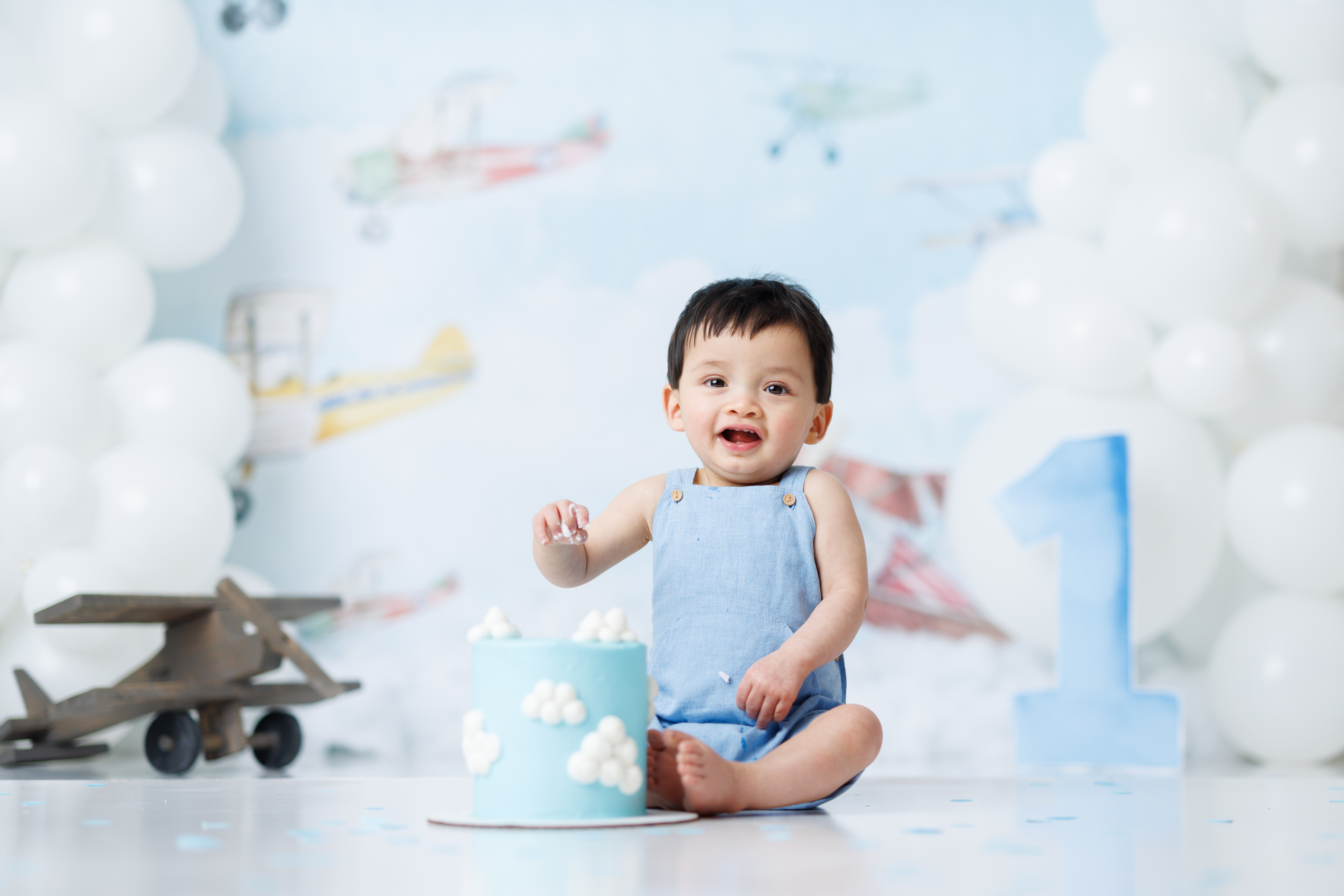 boy eating cloud cake with vintage airplanes 